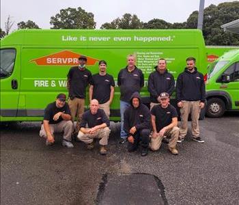 SERVPRO employee in front of green truck