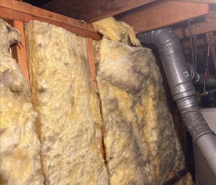 Yellow insulation with black stains.