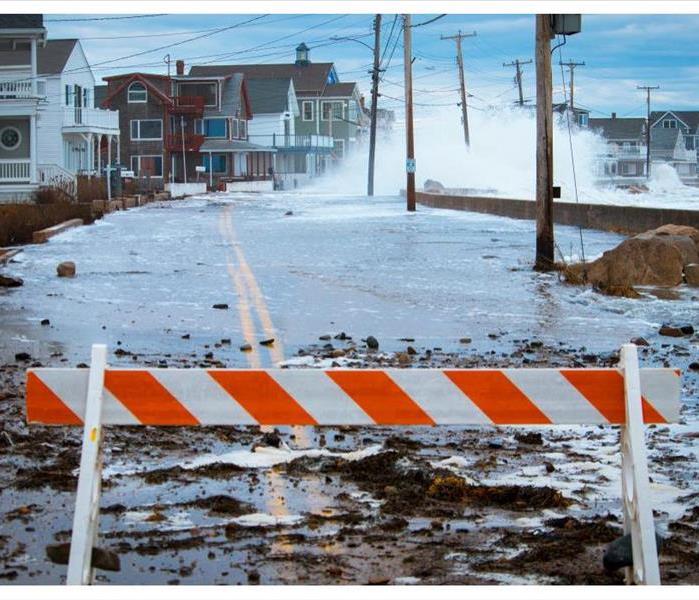 Storm waves crash over the seawall causing massive flooding, power outages, road closures, along the Maine coast